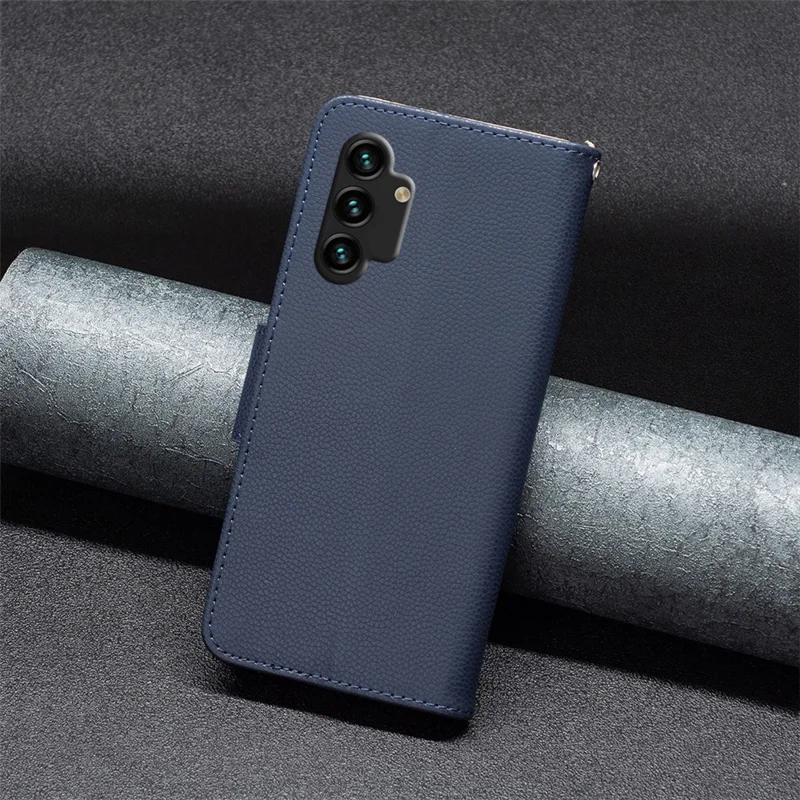For Samsung Galaxy A13 4G / A13 5G / A04 4G (164.4 x 76.3 x 9.1 mm) Magnetic Closure Litchi Texture PU Leather Wallet Solid Color Cell Phone Cover with Strap - Dark Blue
