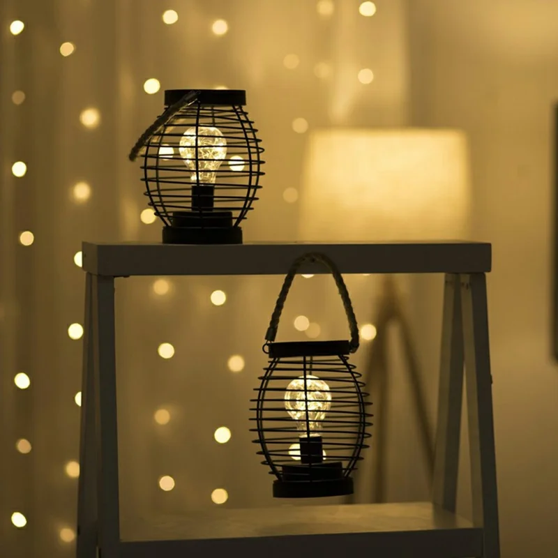Retro Aushöhlen Eisen Kunst Runde Handgehaltene Laterne Tragbare LED Kupferdraht Glühbirne Tischlampe