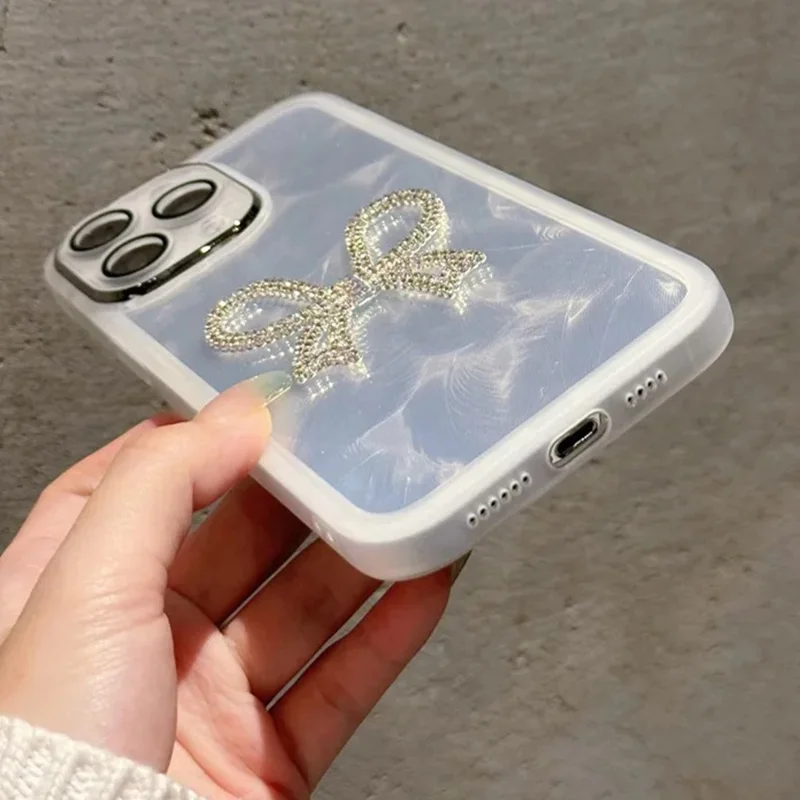 For iPhone 16 Pro Case Electroplating Feather Pattern TPU Phone Cover with Beaded Strap - Sparkling Bow