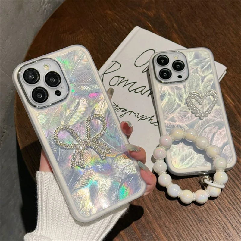 For iPhone 16 Pro Case Electroplating Feather Pattern TPU Phone Cover with Beaded Strap - Sparkling Bow