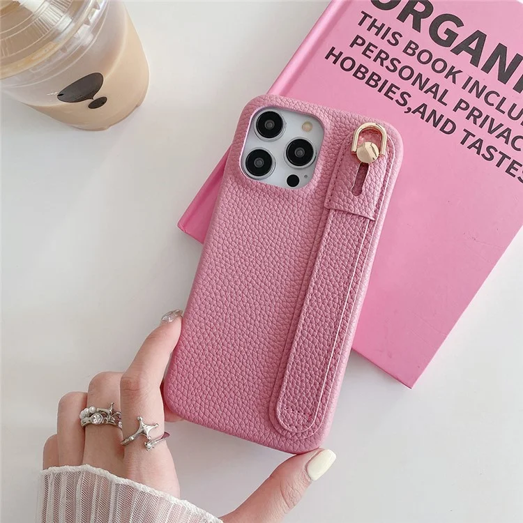 Capa para iPhone 14 Pro Max com suporte para pulso, em couro PU + capa de telefone PET - Rosa