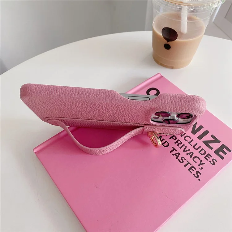 Capa para iPhone 14 Pro Max com suporte para pulso, em couro PU + capa de telefone PET - Rosa