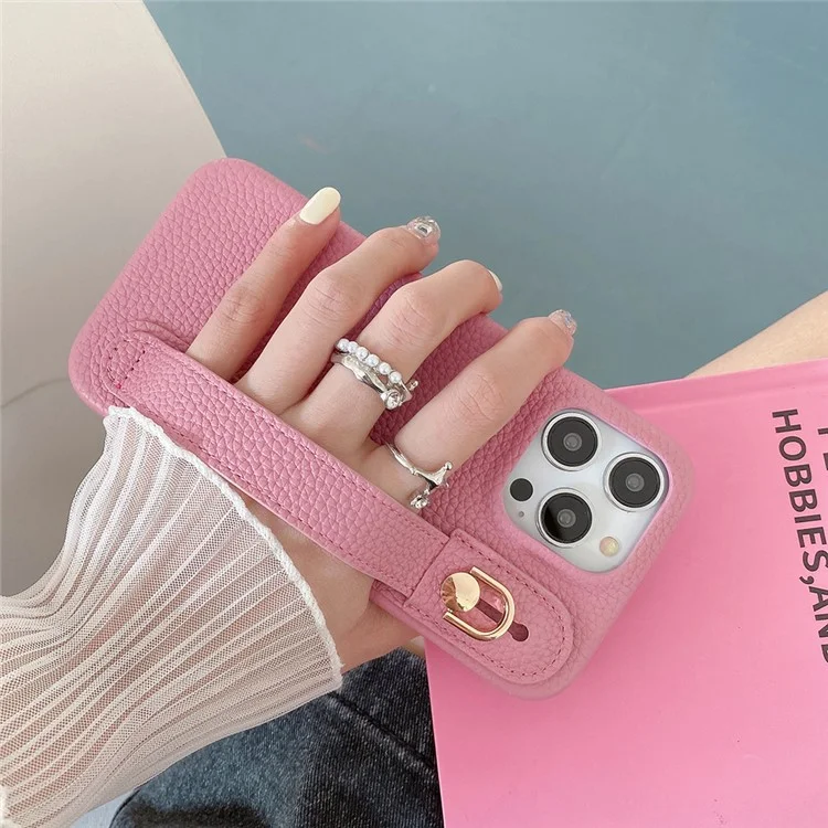 Capa para iPhone 14 Pro Max com suporte para pulso, em couro PU + capa de telefone PET - Rosa