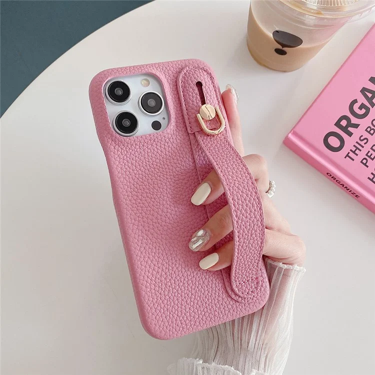 Capa para iPhone 14 Pro Max com suporte para pulso, em couro PU + capa de telefone PET - Rosa