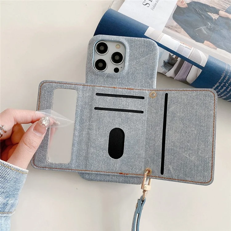 Étui pour iPhone 14 Pro Max avec fentes pour cartes, design miroir, texture en tissu jean et cuir PU avec sangle - Bleu bébé