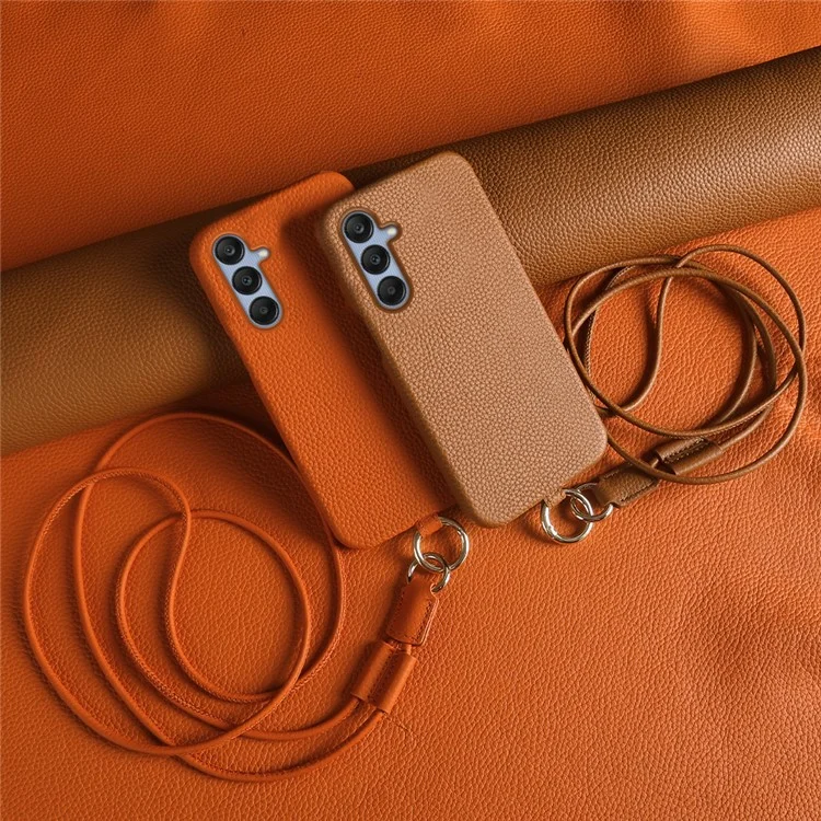 Coque pour Samsung Galaxy S23 FE avec dragonne, en véritable cuir de vache et plastique, coloris orange.