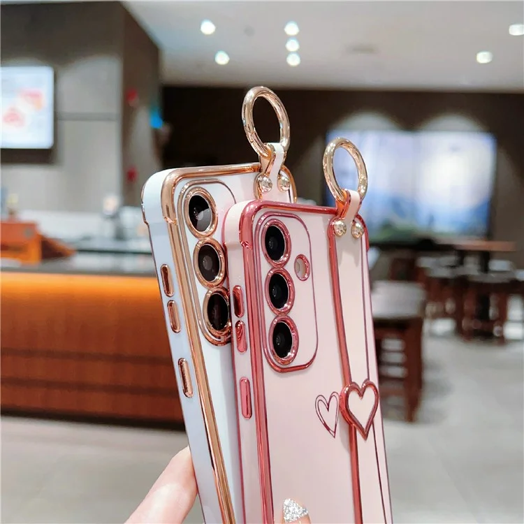 Capa para Samsung Galaxy S25+ Padrão de coração eletroplatinado TPU Capa traseira do telefone com pulseira e suporte - Rosa