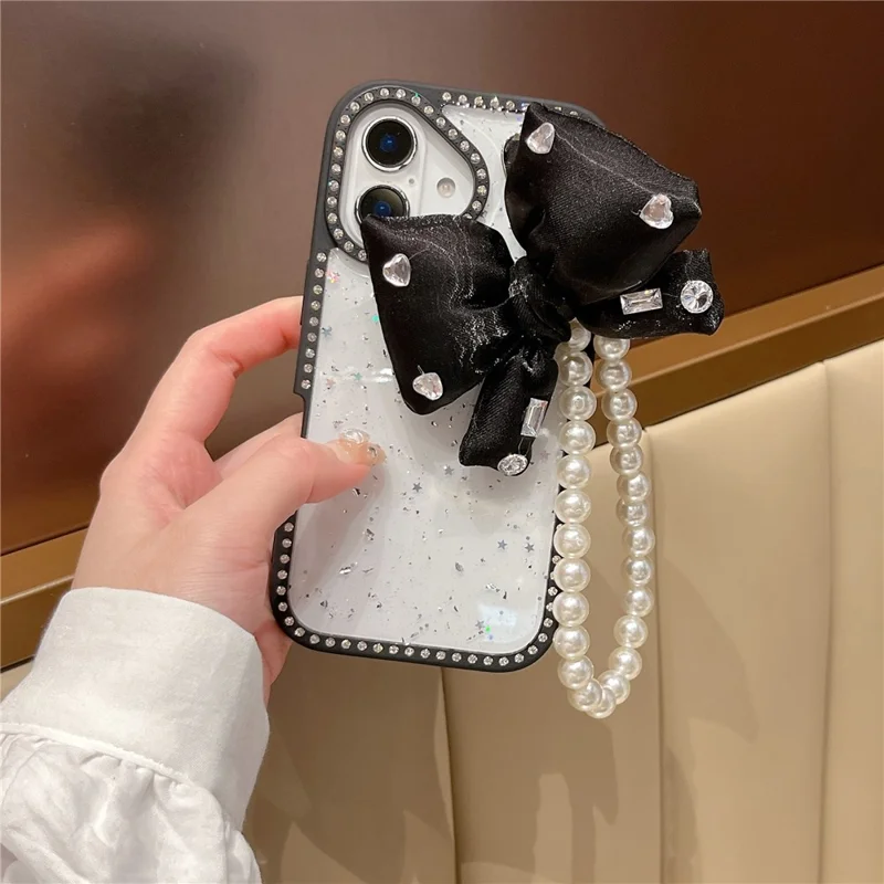For iPhone 16 Case Glitter Epoxy Design TPU + PC Phone Back Cover with Bow Strap, Rhinestone Decor - Black