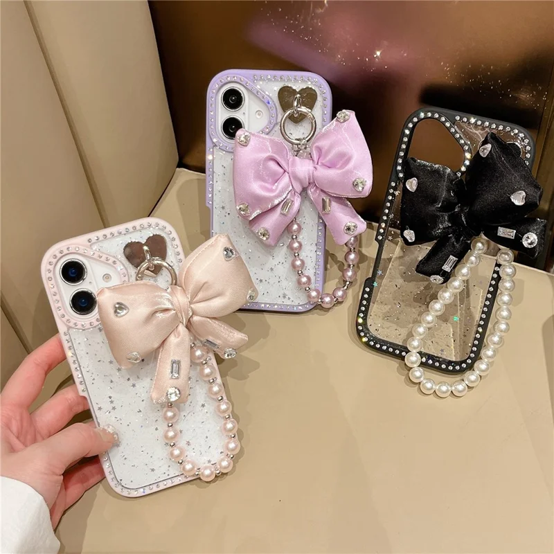 For iPhone 16 Case Glitter Epoxy Design TPU + PC Phone Back Cover with Bow Strap, Rhinestone Decor - Black