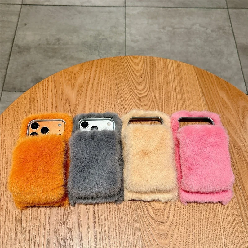 For iPhone 17 Pro Solid Color Fluffy Phone Case Winter Warm Hand Strap TPU Cover - Orange