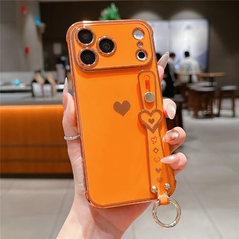 For iPhone 17 Pro Case Wristband Kickstand Electroplated Love Heart TPU Phone Cover Finger Holder - Orange