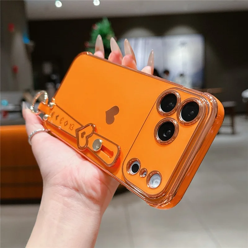 For iPhone 17 Pro Case Wristband Kickstand Electroplated Love Heart TPU Phone Cover Finger Holder - Orange