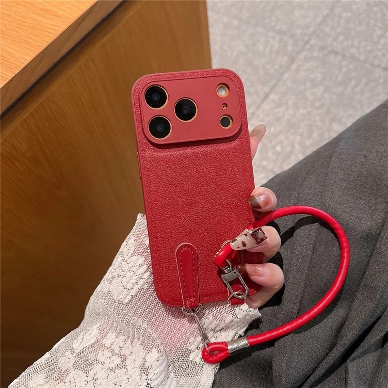 For iPhone 17 Pro Case TPU PU Leather PC Anti-drop Phone Back Cover with Wrist Strap - Red Leather Strip