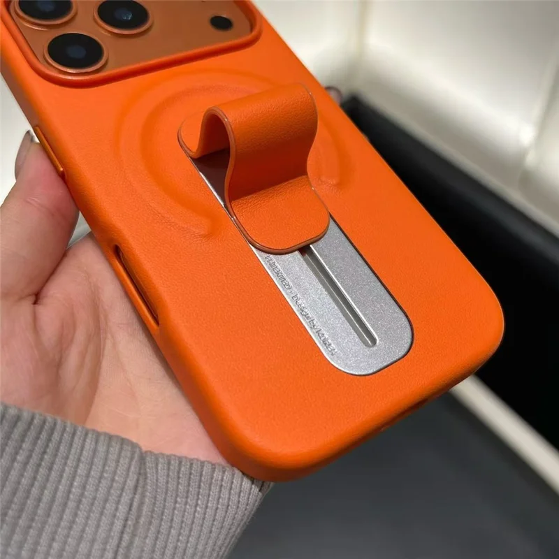 For iPhone 17 Pro Magnetic Case Finger Holder Kickstand PU Leather + PC Phone Cover - Orange