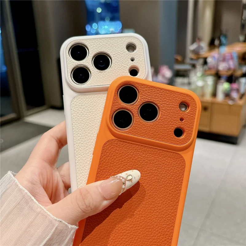 For iPhone 17 Pro Case Lychee Texture Genuine Cow Leather Coated TPU + PC Phone Cover - White  /  Orange