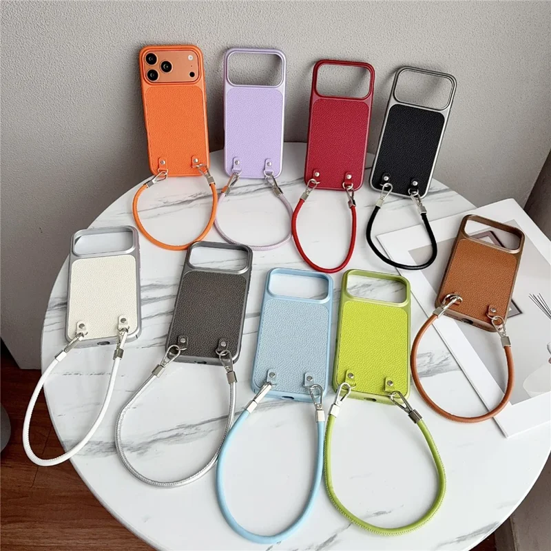 Til iPhone 17 Pro Max Case Metal Paint Litchi-textur PU-læder Telefon Bagdæksel med Håndledrem - Orange