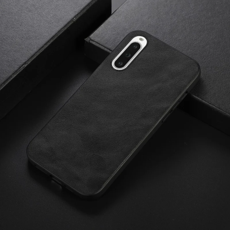 For Sony Xperia 10 V Læderbelagt TPU+PC Telefonbeskyttelsesdæksel Kødhudstekstur Smartphone Cover - Sort