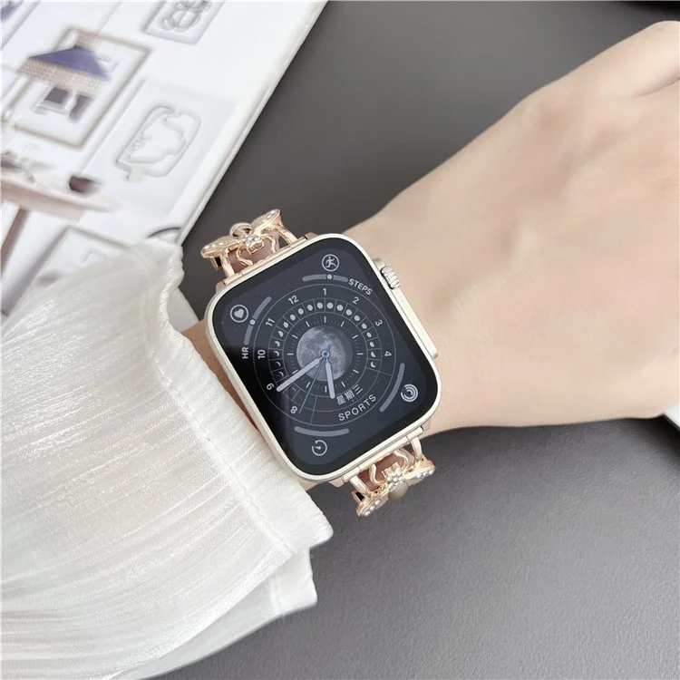 Pour Apple Watch Series 10 46mm / Ultra 2 Ultra 49mm / Series 9 8 7 45mm / 6 5 4 SE (2023) SE (2022) SE 44mm / 3 2 1 42mm Véritable Bracelet en Cuir de Vache Décoration Abeille - Rose