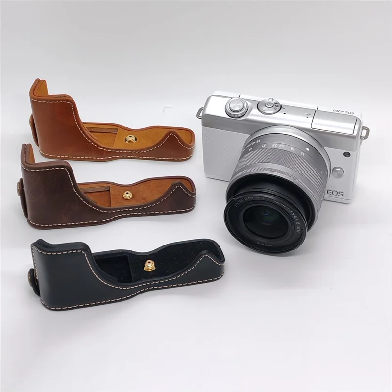 حالة الكاميرا لـ Canon EOS M10 / M100 / M200 غطاء جزئي من الجلد الصناعي مع حزام يد وفتحة قابلة للإزالة لاستبدال البطارية - أسود