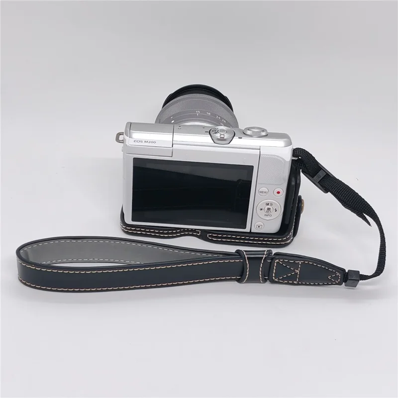 حالة الكاميرا لـ Canon EOS M10 / M100 / M200 غطاء جزئي من الجلد الصناعي مع حزام يد وفتحة قابلة للإزالة لاستبدال البطارية - أسود