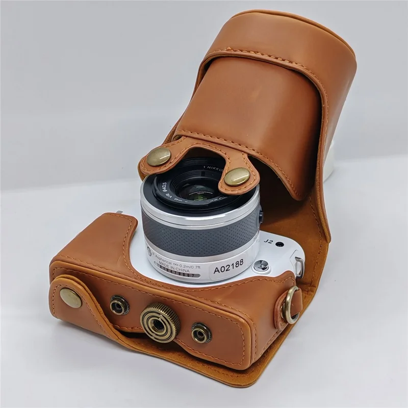 Étui en cuir pour appareil photo Nikon J1 / J2, housse demi-enveloppante avec bandoulière, protection en cuir PU - Café