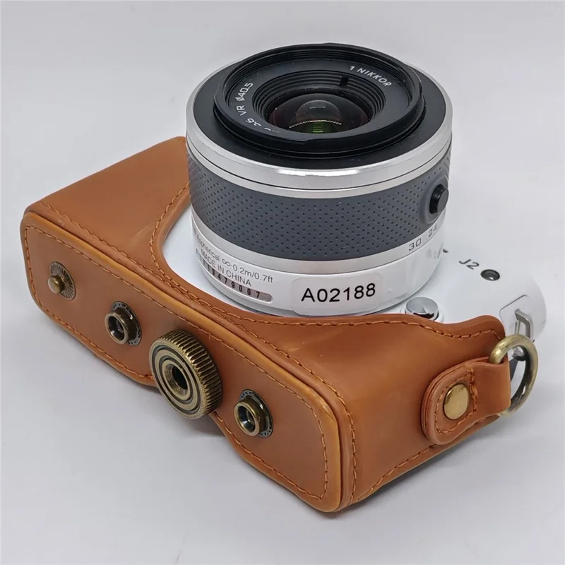 Étui en cuir pour appareil photo Nikon J1 / J2, housse demi-enveloppante avec bandoulière, protection en cuir PU - Café