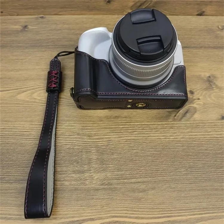 For Canon EOS R50 / R100 PU Leather Bottom Case Half Body Camera Cover with Wrist Strap - Black