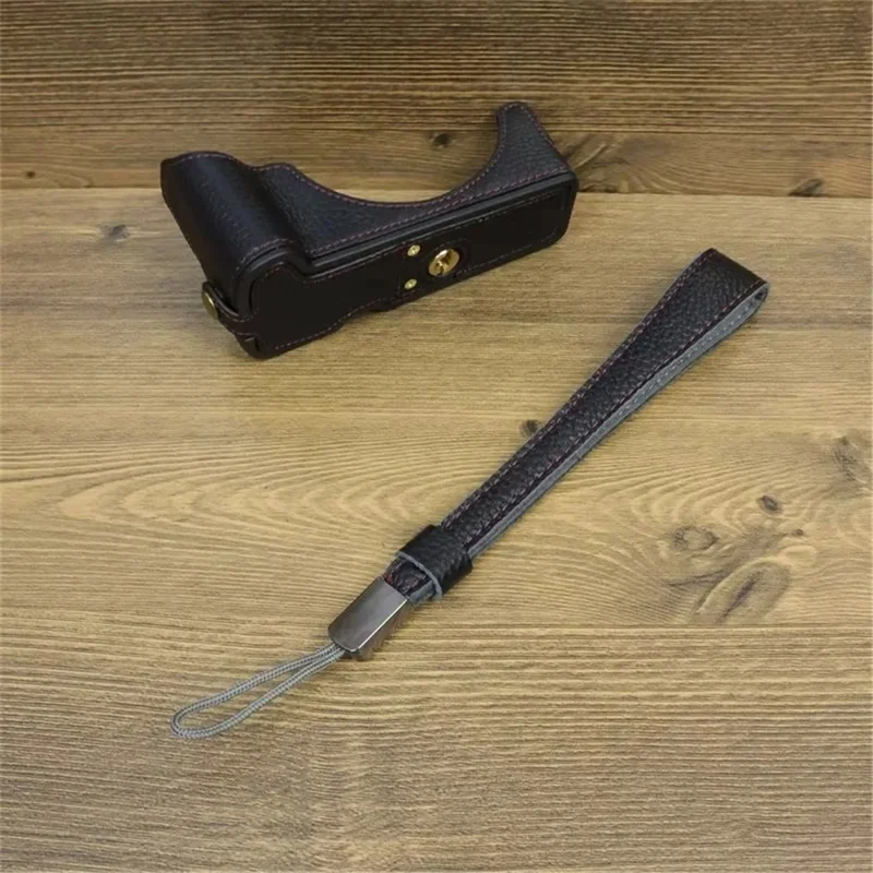 For Canon EOS R50 / R100 Genuine Cow Leather Camera Bottom Case Anti-drop Cover with Wrist Strap - Black