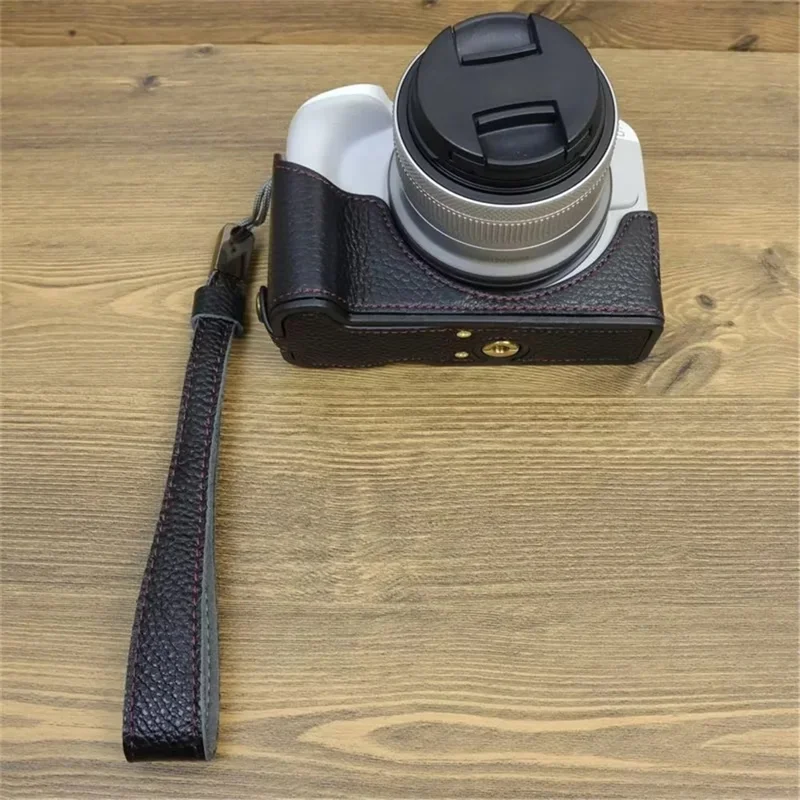 For Canon EOS R50 / R100 Genuine Cow Leather Camera Bottom Case Anti-drop Cover with Wrist Strap - Black
